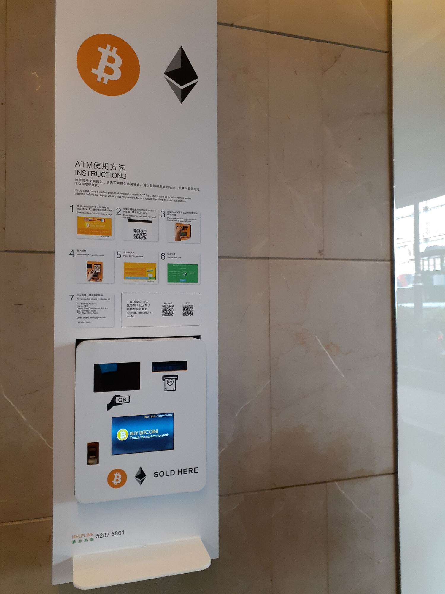 香港铜锣湾街头的一台比特币 ATM，机身上写着买币的操作步骤。